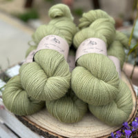 Five skeins of green laceweight yarn