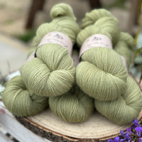 Five skeins of green laceweight yarn