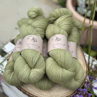 Five skeins of green laceweight yarn