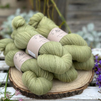 Five skeins of green laceweight yarn