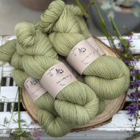 Five skeins of green laceweight yarn