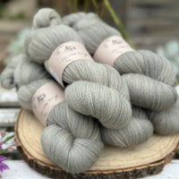 Five skeins of grey laceweight yarn