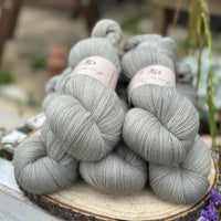 Five skeins of grey laceweight yarn