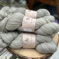 Five skeins of grey laceweight yarn