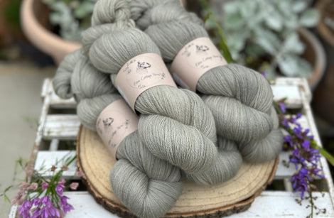 Five skeins of grey laceweight yarn