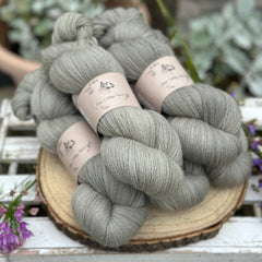 Five skeins of grey laceweight yarn