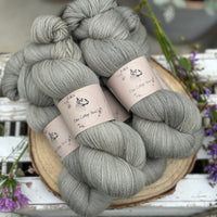 Five skeins of grey laceweight yarn