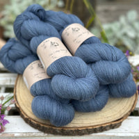 Five skeins of blue laceweight yarn