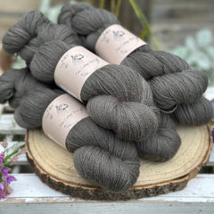 Five skeins of dark grey laceweight yarn