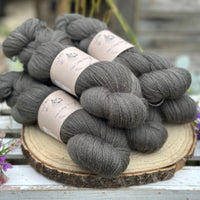 Five skeins of dark grey laceweight yarn