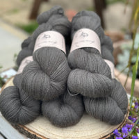 Five skeins of dark grey laceweight yarn