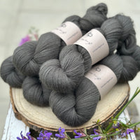 Five skeins of dark grey laceweight yarn