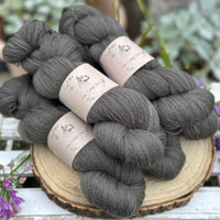 Five skeins of dark grey laceweight yarn