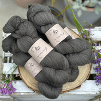 Five skeins of dark grey laceweight yarn