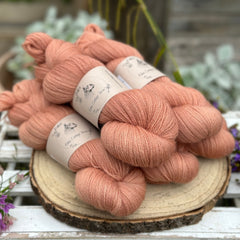 Five skeins of orangey pink yarn