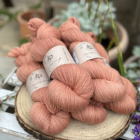 Five skeins of orangey pink yarn