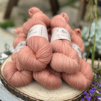 Five skeins of orangey pink yarn