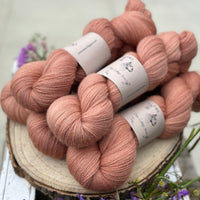 Five skeins of orangey pink yarn