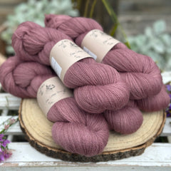 Five skeins of purple laceweight yarn