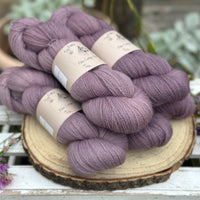 Five skeins of purple laceweight yarn