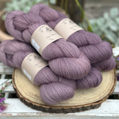 Five skeins of purple laceweight yarn