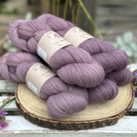 Five skeins of purple laceweight yarn