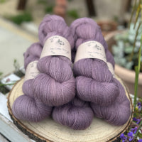 Five skeins of purple laceweight yarn