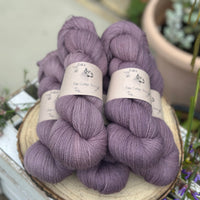 Five skeins of purple laceweight yarn