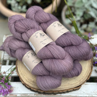 Five skeins of purple laceweight yarn