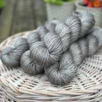 Four skeins of grey yarn