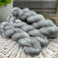 Four skeins of grey yarn