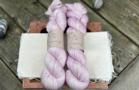 Two skeins of pale pink yarn