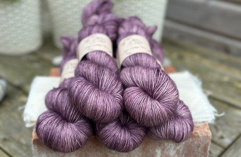 Five skeins of purple yarn