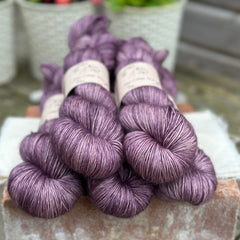 Five skeins of purple yarn