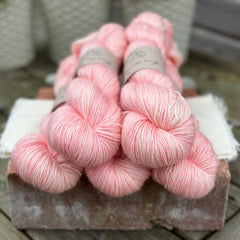 Five skeins of pink yarn
