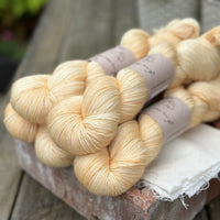 Five skeins of pale yellow yarn