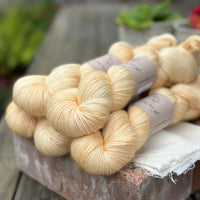 Five skeins of pale yellow yarn