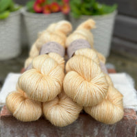 Five skeins of pale yellow yarn