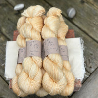 Five skeins of pale yellow yarn