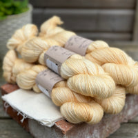 Five skeins of pale yellow yarn