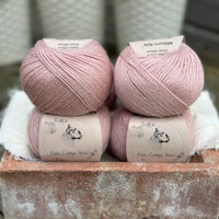 Balls of pale pink yarn