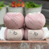 Balls of pale pink yarn