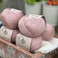 Balls of pale pink yarn