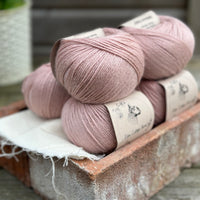 Balls of pale pink yarn