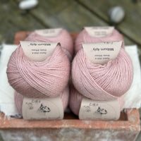 Balls of pale pink yarn