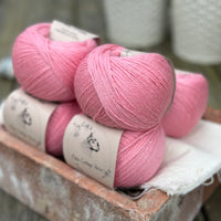 Balls of bright pink yarn