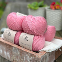 Balls of bright pink yarn