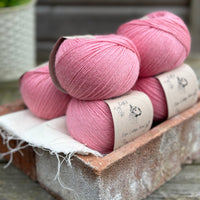 Balls of bright pink yarn