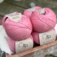 Balls of bright pink yarn