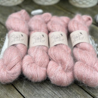 Four skeins of fluffy pink yarn